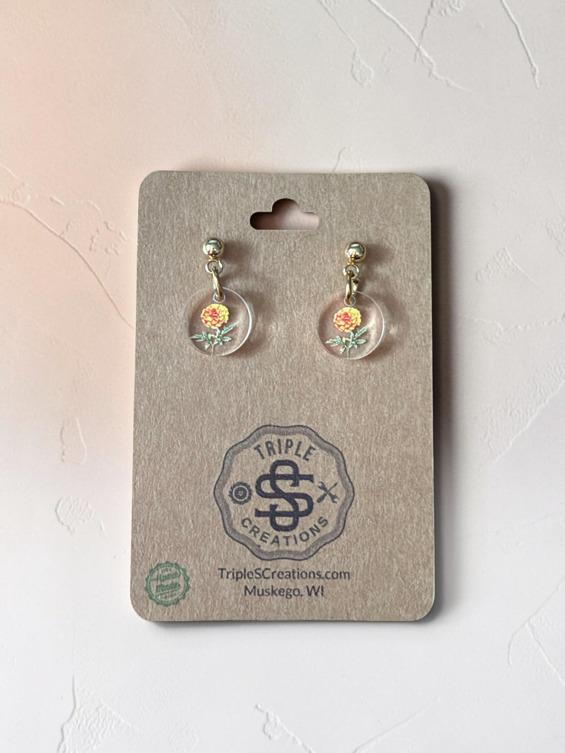 Birth flower earrings with full-color acrylic charms on a Triple S Creations card