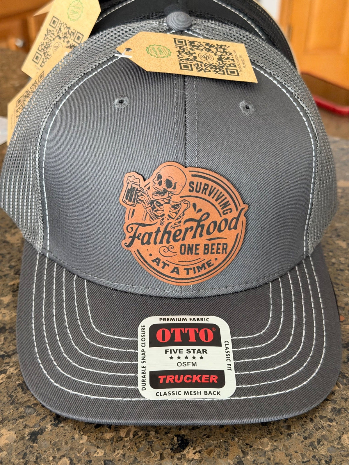 Grey trucker hat with leather Fatherhood beer patch