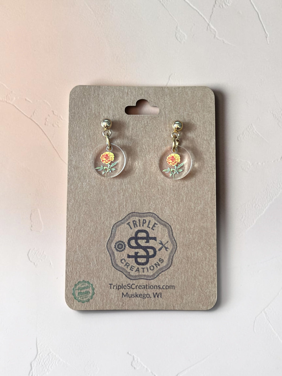 October Marigold birth flower earrings with gold studs on a Triple S Creations card